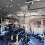Severely burned interior kitchen after residential fire damage