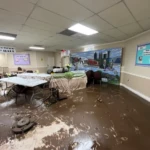 Commercial building interior flooded with standing water after storm damage