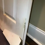 Damaged drywall removed to access moisture behind walls