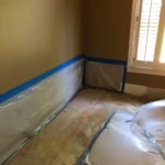 Interior room prepared for repair with protective plastic barriers